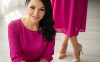 žena v ružových šatách a béžových lodičkách stojaca na svetlej drevenej podlahe